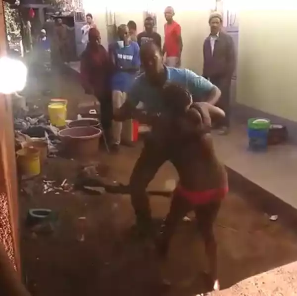 Neighbours stand and watch as man beats his wife almost to death for cheating